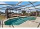 Refreshing screened-in pool with surrounding deck and patio, perfect for outdoor entertaining at 410 Canna Dr, Davenport, FL 33897