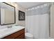 Charming bathroom featuring a classic vanity with a framed mirror and shower with curtain at 4820 Conway Rd # 130, Orlando, FL 32812