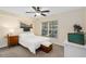 Cozy bedroom with a ceiling fan, a bright window, and a comfortable bed with neutral decor at 4820 Conway Rd # 130, Orlando, FL 32812