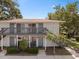 Exterior view of a multi-story condo building with well-maintained landscaping at 4820 Conway Rd # 130, Orlando, FL 32812