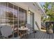 Condo entrance featuring an outdoor seating area and stylish gray door at 4820 Conway Rd # 130, Orlando, FL 32812