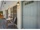 Condo entrance featuring an outdoor seating area and stylish gray door at 4820 Conway Rd # 130, Orlando, FL 32812
