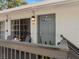 Charming condo entrance featuring a cozy outdoor seating area and stylish gray door at 4820 Conway Rd # 130, Orlando, FL 32812