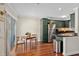 Well-lit eat in kitchen with stainless steel appliances, dark countertops and green cabinets, and hardwood floors at 4820 Conway Rd # 130, Orlando, FL 32812
