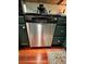 Stainless steel dishwasher with dark green cabinetry and hardwood floors at 4820 Conway Rd # 130, Orlando, FL 32812