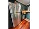 Kitchen with stainless steel refrigerator, dishwasher and dark green cabinets and countertops at 4820 Conway Rd # 130, Orlando, FL 32812
