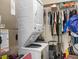 Convenient laundry closet with stacked washer and dryer units and additional storage space at 4820 Conway Rd # 130, Orlando, FL 32812