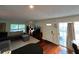 Open-concept living room featuring hardwood floors, a comfortable sectional sofa, and plenty of lighting at 4820 Conway Rd # 130, Orlando, FL 32812