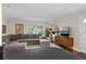Inviting living room features hardwood floors, a large grey sectional sofa, and bright natural light at 4820 Conway Rd # 130, Orlando, FL 32812