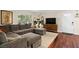 Comfortable living room featuring a large sectional sofa and abundant natural light at 4820 Conway Rd # 130, Orlando, FL 32812