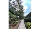 Community path surrounded by mature trees and lush landscaping offers a tranquil experience at 4820 Conway Rd # 130, Orlando, FL 32812