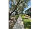 Shaded community path between residential buildings is surrounded by beautiful green grass and well-maintained landscaping at 4820 Conway Rd # 130, Orlando, FL 32812