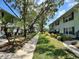 Well-manicured landscaping lines the walkway between beautiful condo buildings at 4820 Conway Rd # 130, Orlando, FL 32812