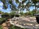 Exterior common picnic area with stone picnic tables nestled beneath the shade of mature trees at 4820 Conway Rd # 130, Orlando, FL 32812