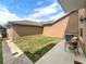A cozy backyard features green grass, an outdoor seating arrangement and space for entertaining guests at 4909 Terrapin Blvd, St Cloud, FL 34771
