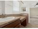 Bathroom featuring double sinks, neutral walls, a large mirror, and tiled floors at 4909 Terrapin Blvd, St Cloud, FL 34771