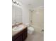 Neutral full bath features a tub shower combo, wood vanity, and updated fixtures at 4909 Terrapin Blvd, St Cloud, FL 34771