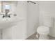 Cozy bathroom features a pedestal sink, updated toilet, and neutral tile flooring at 4909 Terrapin Blvd, St Cloud, FL 34771