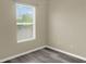 Neutral bedroom with wood-look flooring and a large window at 4909 Terrapin Blvd, St Cloud, FL 34771