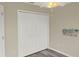 Bedroom with wood-look flooring, bi-fold closet, and accent wall decor at 4909 Terrapin Blvd, St Cloud, FL 34771