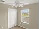Bedroom with neutral walls, carpeted flooring, and a bright window with blinds at 4909 Terrapin Blvd, St Cloud, FL 34771