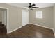 Bedroom with wood-look floors, a ceiling fan, and a window letting in natural light at 4909 Terrapin Blvd, St Cloud, FL 34771