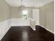 Dining room features dark wood floors, wainscoting, and a modern chandelier at 4909 Terrapin Blvd, St Cloud, FL 34771