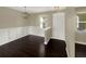 Dining room features dark wood floors, wainscoting, a modern chandelier, and a front door at 4909 Terrapin Blvd, St Cloud, FL 34771