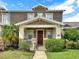 Charming townhome featuring a welcoming front porch and a neatly landscaped yard at 4909 Terrapin Blvd, St Cloud, FL 34771