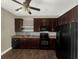 Kitchen boasts stainless steel appliances, granite countertops, tile backsplash, and dark wood cabinets at 4909 Terrapin Blvd, St Cloud, FL 34771