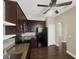 Kitchen boasts stainless steel appliances, granite countertops, tile backsplash, and dark wood cabinets at 4909 Terrapin Blvd, St Cloud, FL 34771