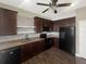 Kitchen boasts stainless steel appliances, granite countertops, tile backsplash, and dark wood cabinets at 4909 Terrapin Blvd, St Cloud, FL 34771