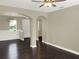Bright living room featuring dark hardwood floors and archways to adjoining rooms at 4909 Terrapin Blvd, St Cloud, FL 34771