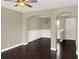 Open-concept living area with dark hardwood floors and elegant archways throughout at 4909 Terrapin Blvd, St Cloud, FL 34771
