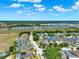 An aerial view of a neighborhood, where a highlighted home is located in a well-maintained community at 550 Castlemain Cir, Davenport, FL 33897