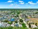An expansive view of a residential community with diverse housing, including a scenic pond, and natural surroundings at 550 Castlemain Cir, Davenport, FL 33897