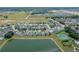 Aerial shot of a neighborhood's lush landscaping with homes and pools overlooking a serene lake at 550 Castlemain Cir, Davenport, FL 33897