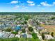 Aerial view showing a highlighted house in a residential neighborhood with a pond and lush surroundings at 550 Castlemain Cir, Davenport, FL 33897