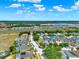 Aerial view showcasing a well-planned neighborhood with homes, landscaping, and community spaces under a partly cloudy sky at 550 Castlemain Cir, Davenport, FL 33897