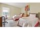 Bedroom with wood-look floors, colorful artwork, and two twin beds at 550 Castlemain Cir, Davenport, FL 33897