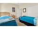 Bedroom features wood-look floors and two twin beds with closet and dresser at 550 Castlemain Cir, Davenport, FL 33897