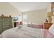 Bedroom with wood-look floors, two twin beds, desk, and green wardrobe at 550 Castlemain Cir, Davenport, FL 33897