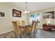 Bright dining room featuring new floors, a modern light fixture, and natural light at 550 Castlemain Cir, Davenport, FL 33897