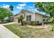 A beautiful single-story home showcasing lush landscaping and a well-maintained lawn at 550 Castlemain Cir, Davenport, FL 33897