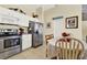 Eat-in kitchen with stainless steel appliances, and a cozy dining area with natural light at 550 Castlemain Cir, Davenport, FL 33897
