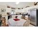 Eat-in kitchen features white cabinets and stainless steel appliances, plus table for dining at 550 Castlemain Cir, Davenport, FL 33897