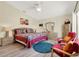Main bedroom featuring wood-look floors, ceiling fan, and two red accent chairs at 550 Castlemain Cir, Davenport, FL 33897