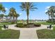 Park featuring a serene lake with a fountain, benches, and lush landscaping for relaxation and enjoyment at 550 Castlemain Cir, Davenport, FL 33897
