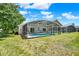 Picturesque screened-in pool area with lush greenery, offering a serene outdoor retreat at 550 Castlemain Cir, Davenport, FL 33897