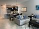 Dining room with modern furnishings and pendant lighting, adjacent to the open-concept kitchen at 637 Ocean Course Ave, Davenport, FL 33896
